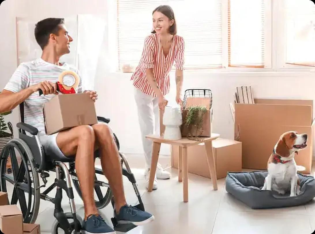 Couple packing moving boxes in accessible home