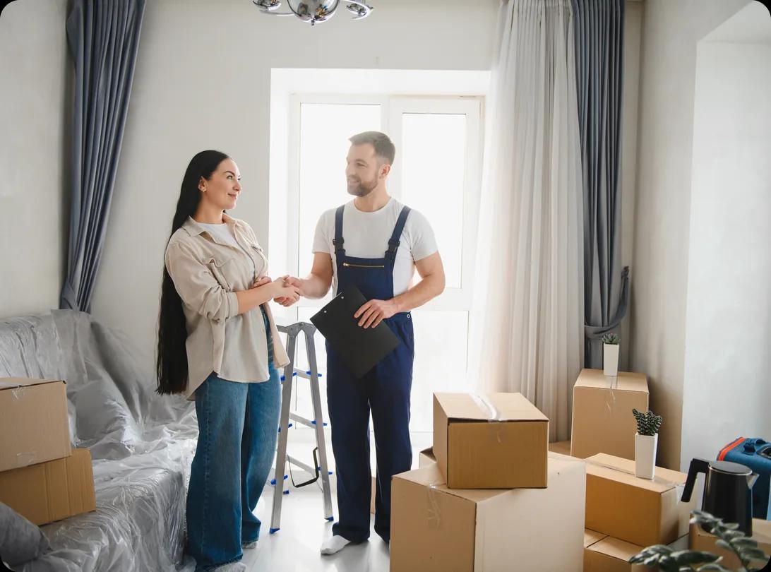 Woman homeowner shaking hands with a professional mover