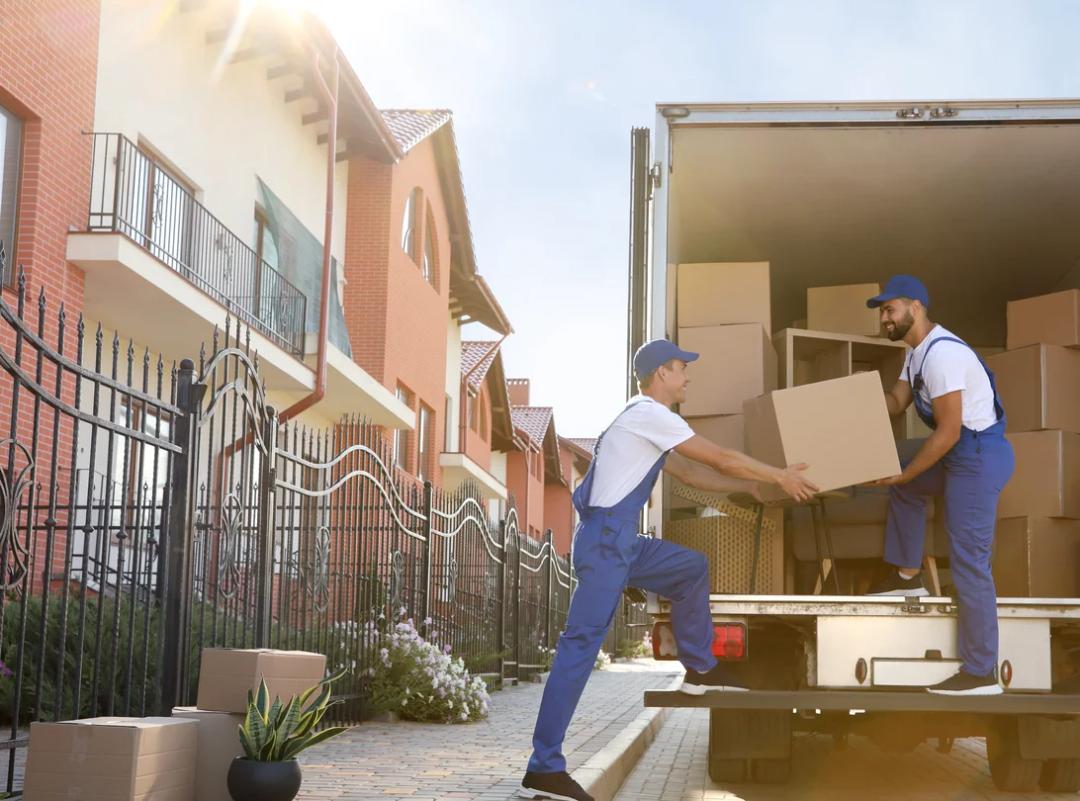 Movers loading a moving truck with boxes
