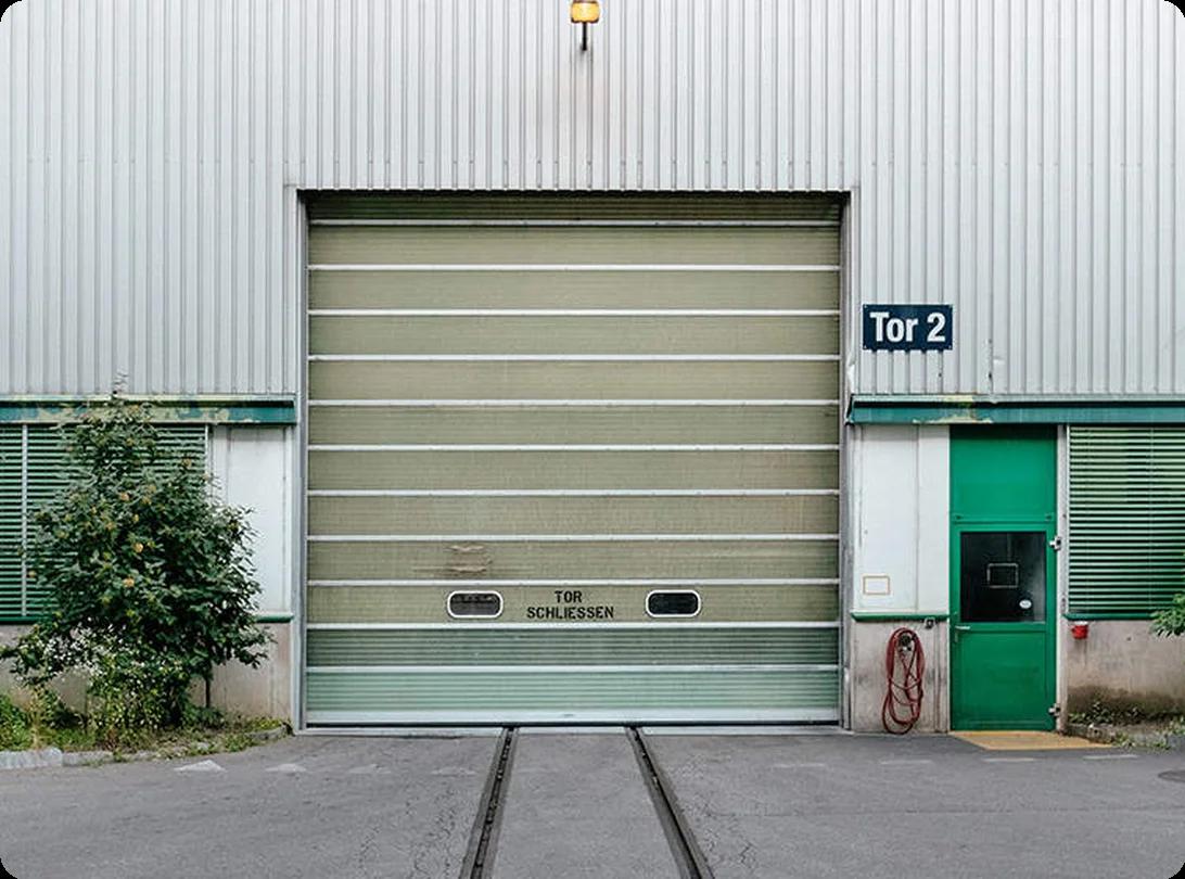 A row of yellow self-storage unit doors lined up under a bright blue sky