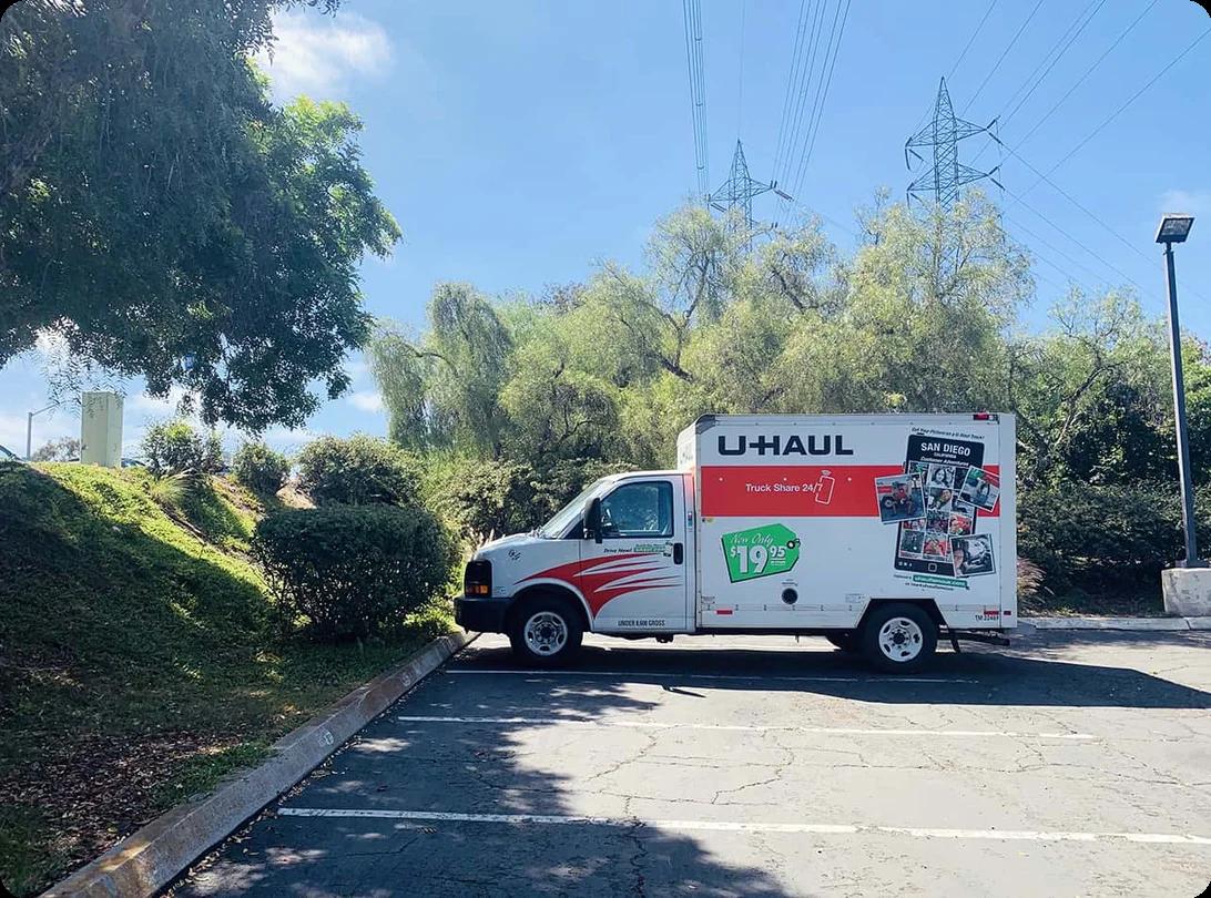 A U-Haul moving truck parked outside displaying the classic $19.95 rental sign