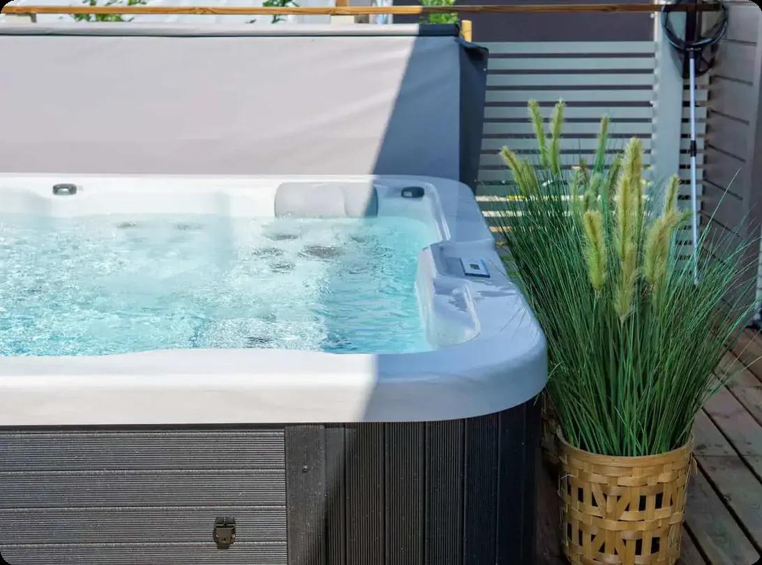 a hot tub set up on a backyard patio
