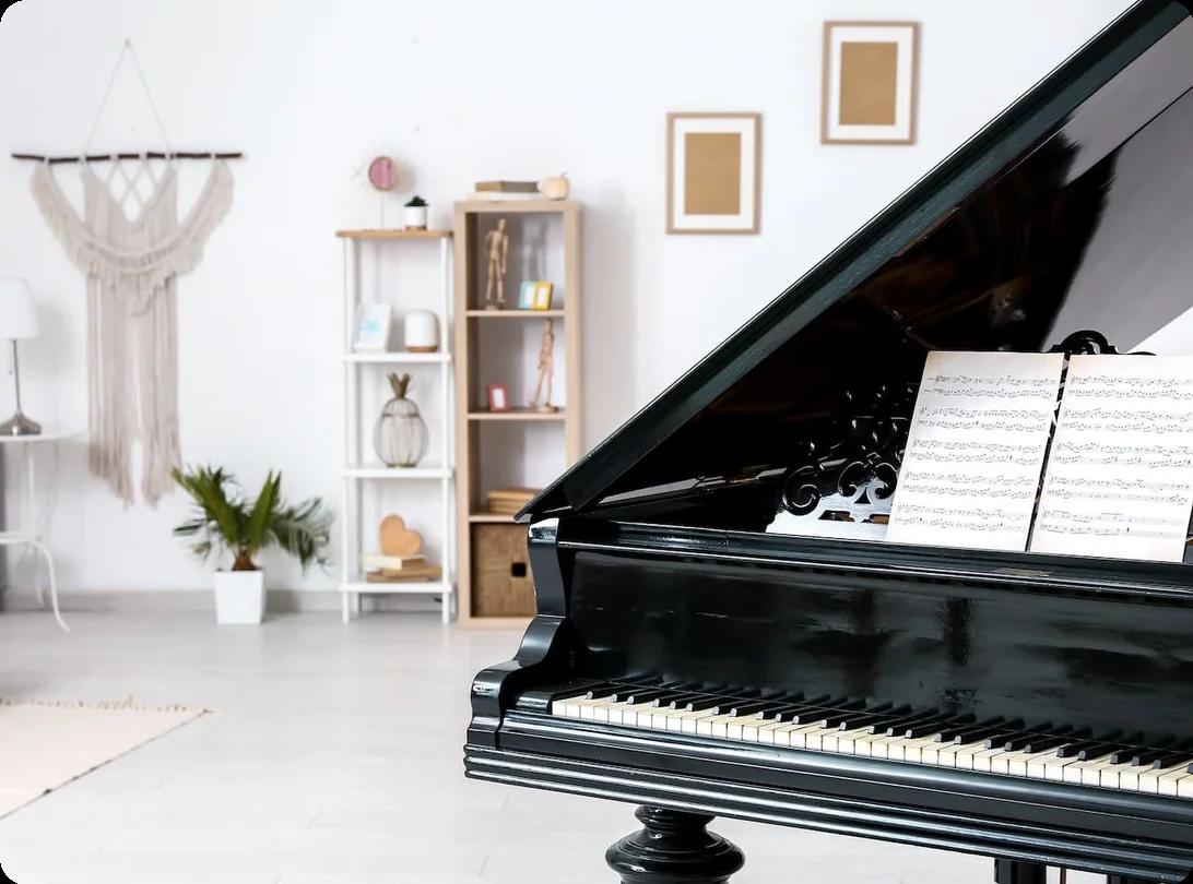 A piano sits in a living room. The photo is shot in such a way that the piano takes up only half of the frame, showing the rest of the room in the other half