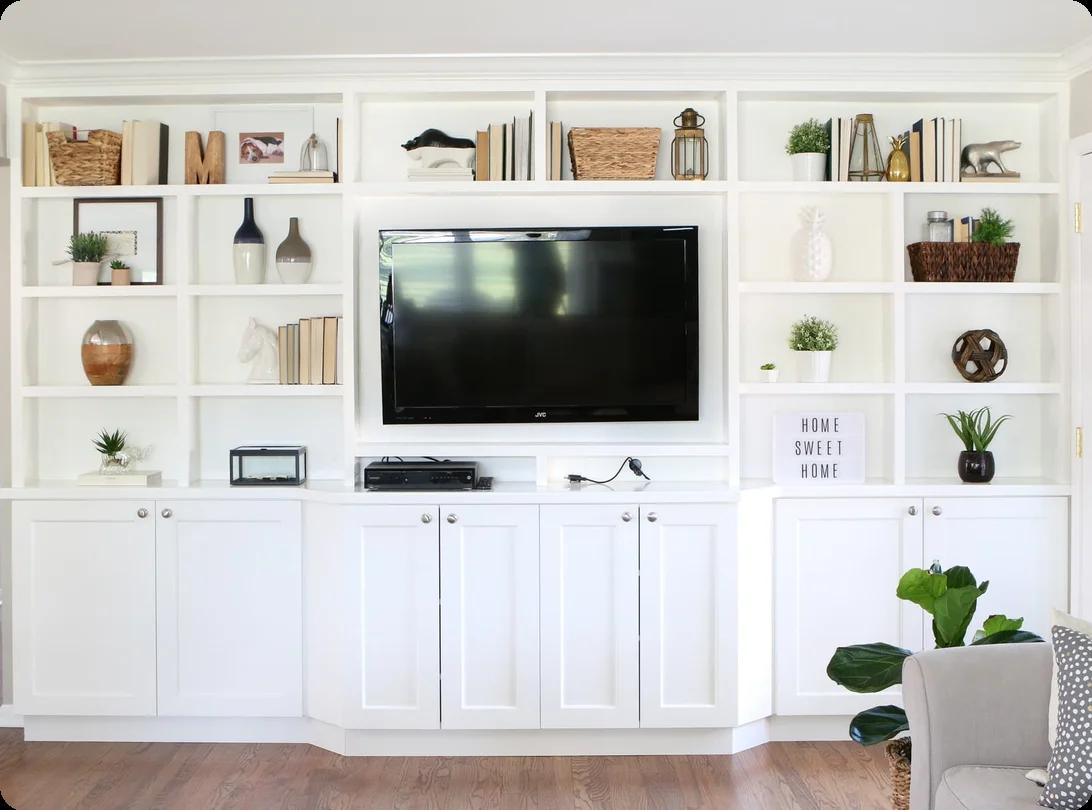 A homeowner using plastic wrap to bundle books and shelf contents together before packing the entire shelf for a move