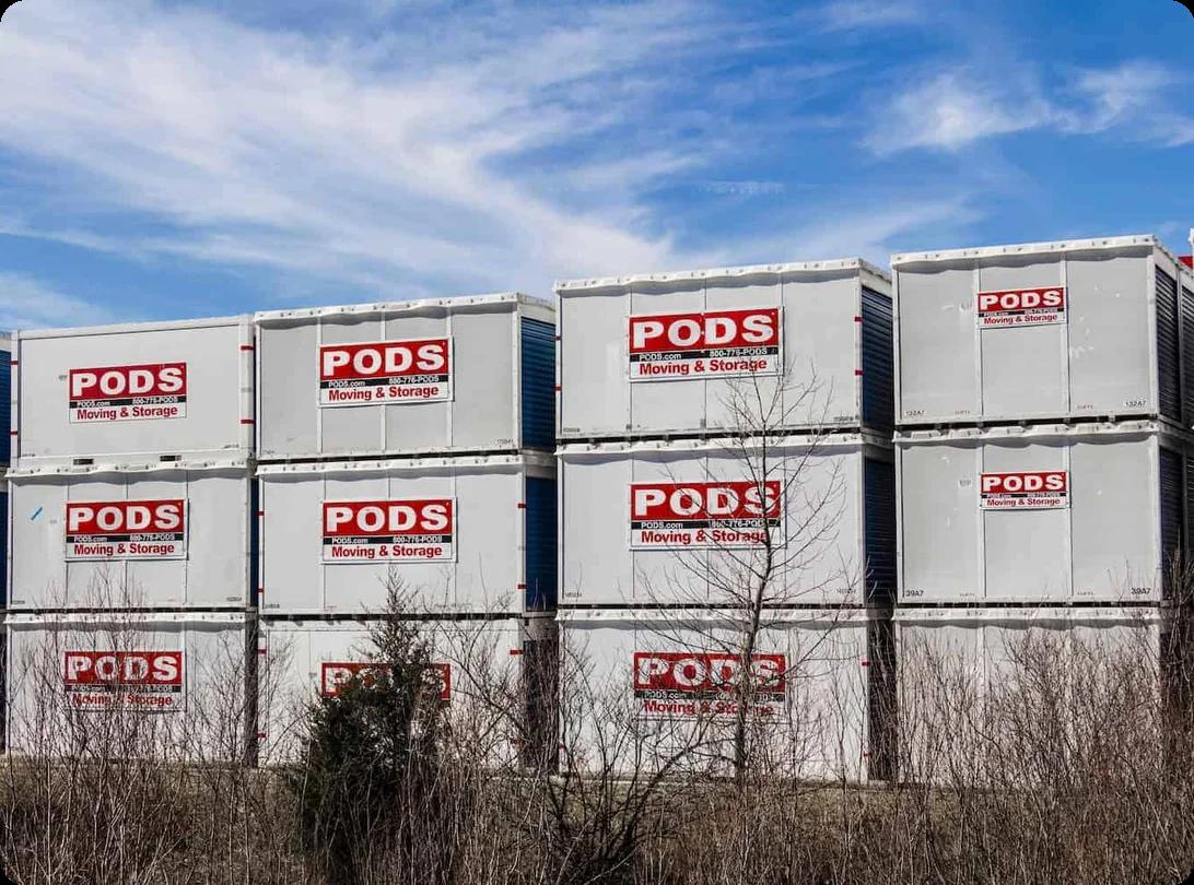 Many PODS containers are stacked on top of each other at a storage facility