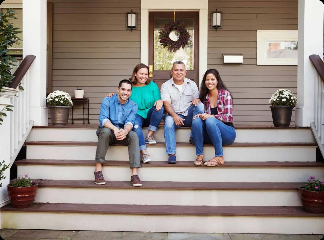 A family sitting together on the front porch