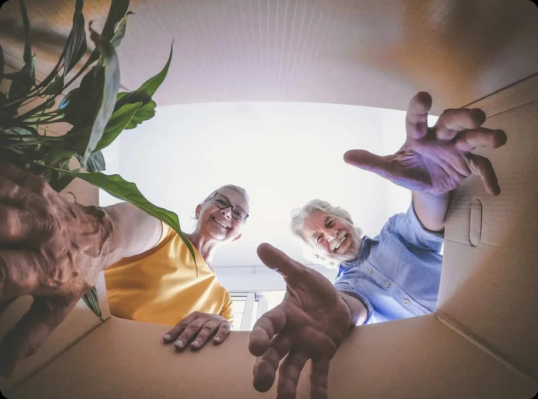 Older adults opening a moving box