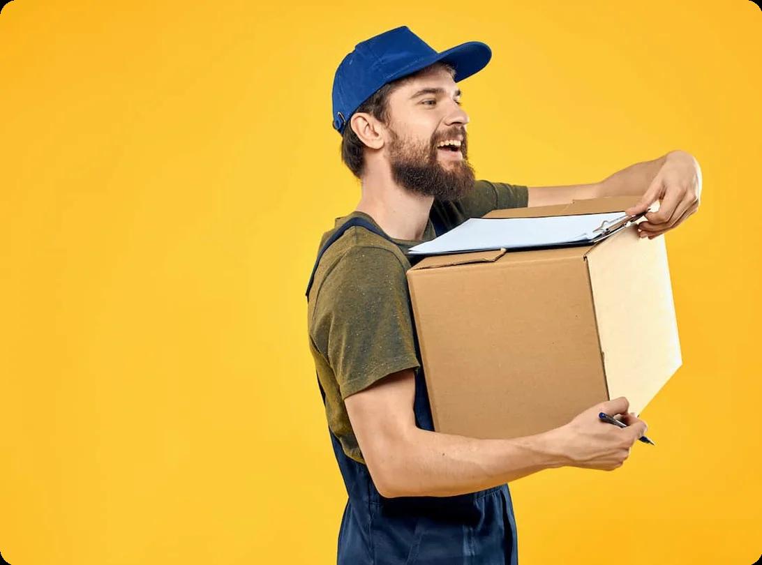 A man carrying a moving box