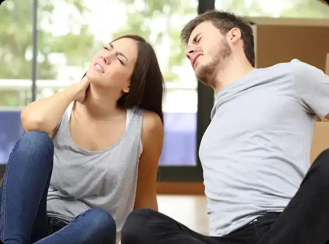 Couple with back and neck pain after lifting boxes during a move
