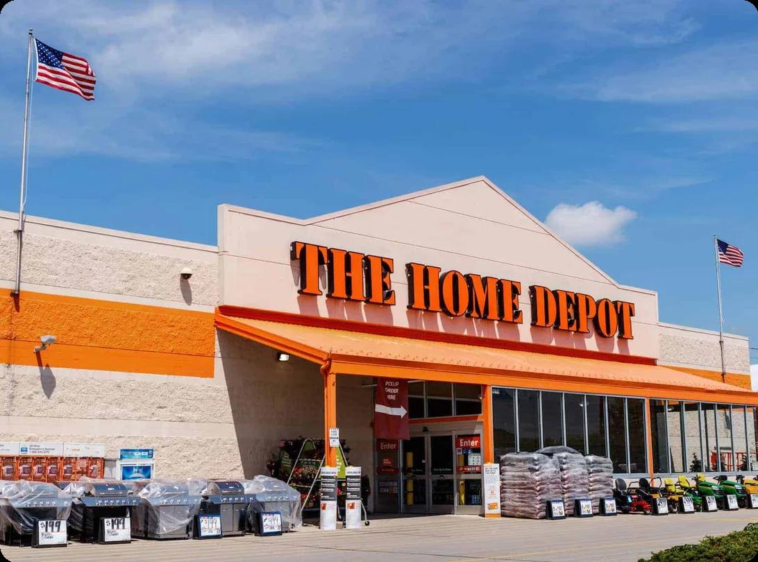 the front facade of a home depot. Product displays and the entrance can be seen.