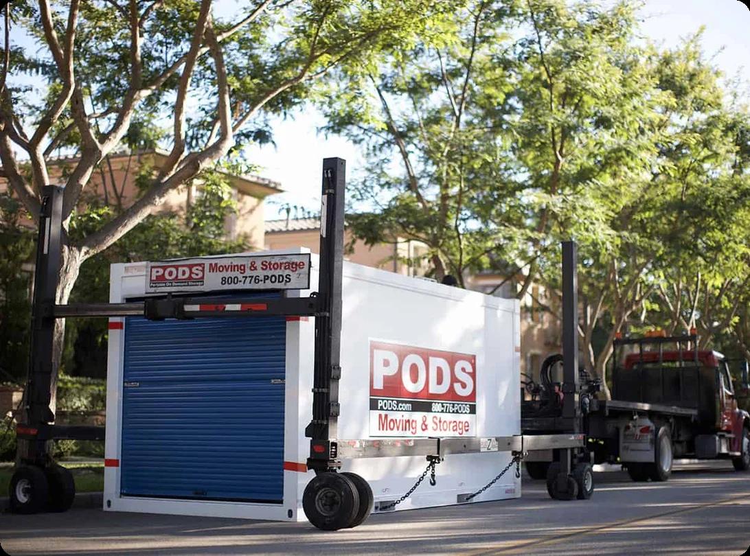 Two portable moving containers parked on a residential street, ready to be loaded