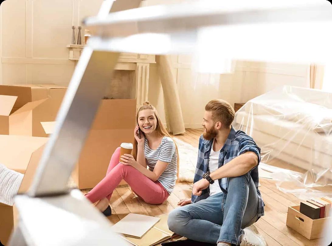 A homeowner using clever packing and unpacking life hacks like color-coded labels and reusable bins in a kitchen