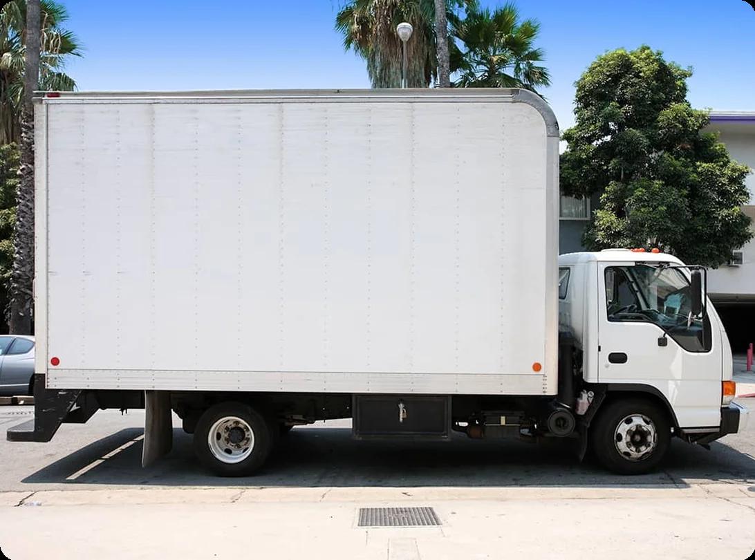 A row of rental moving trucks of different sizes lined up at a rental facility ready for booking