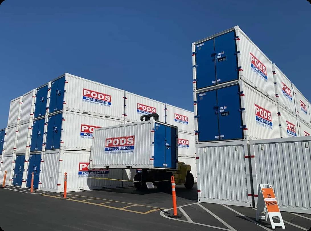 A portable moving container being delivered to a residential driveway for a long-distance relocation