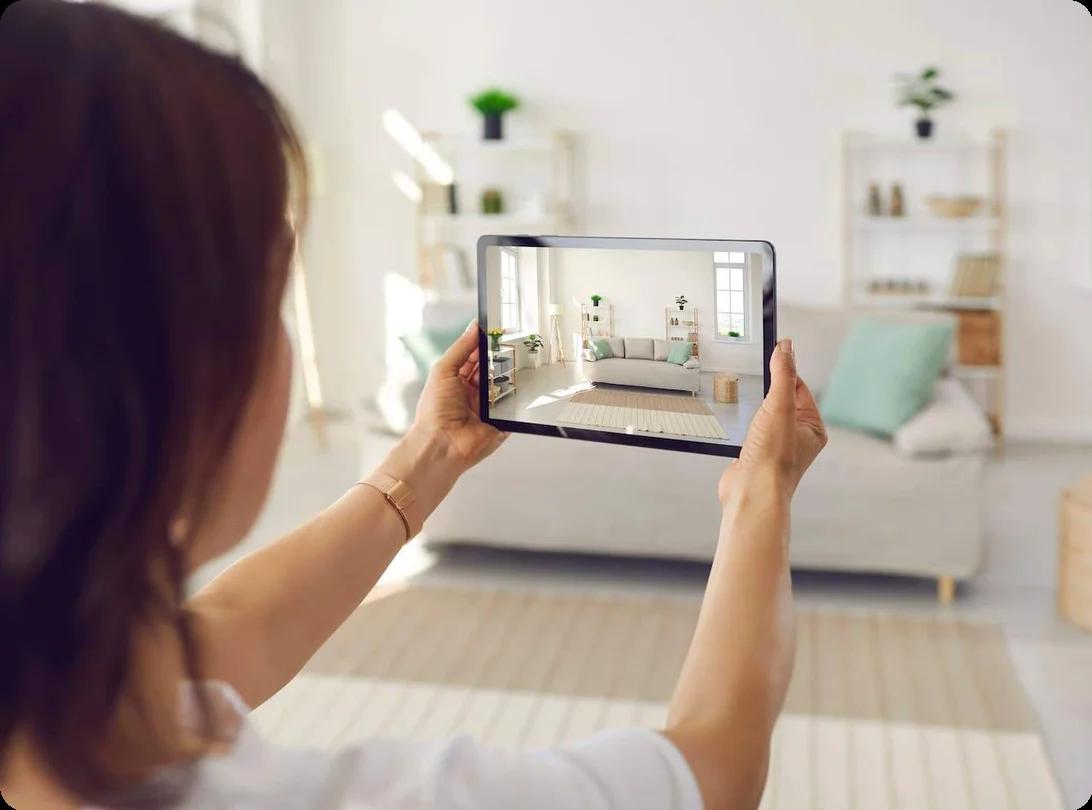 a woman takes a photo of her living room