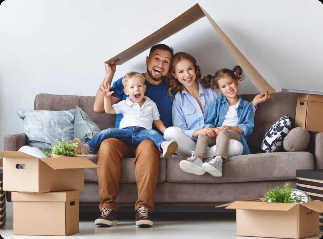 A family with kids playing with moving boxes
