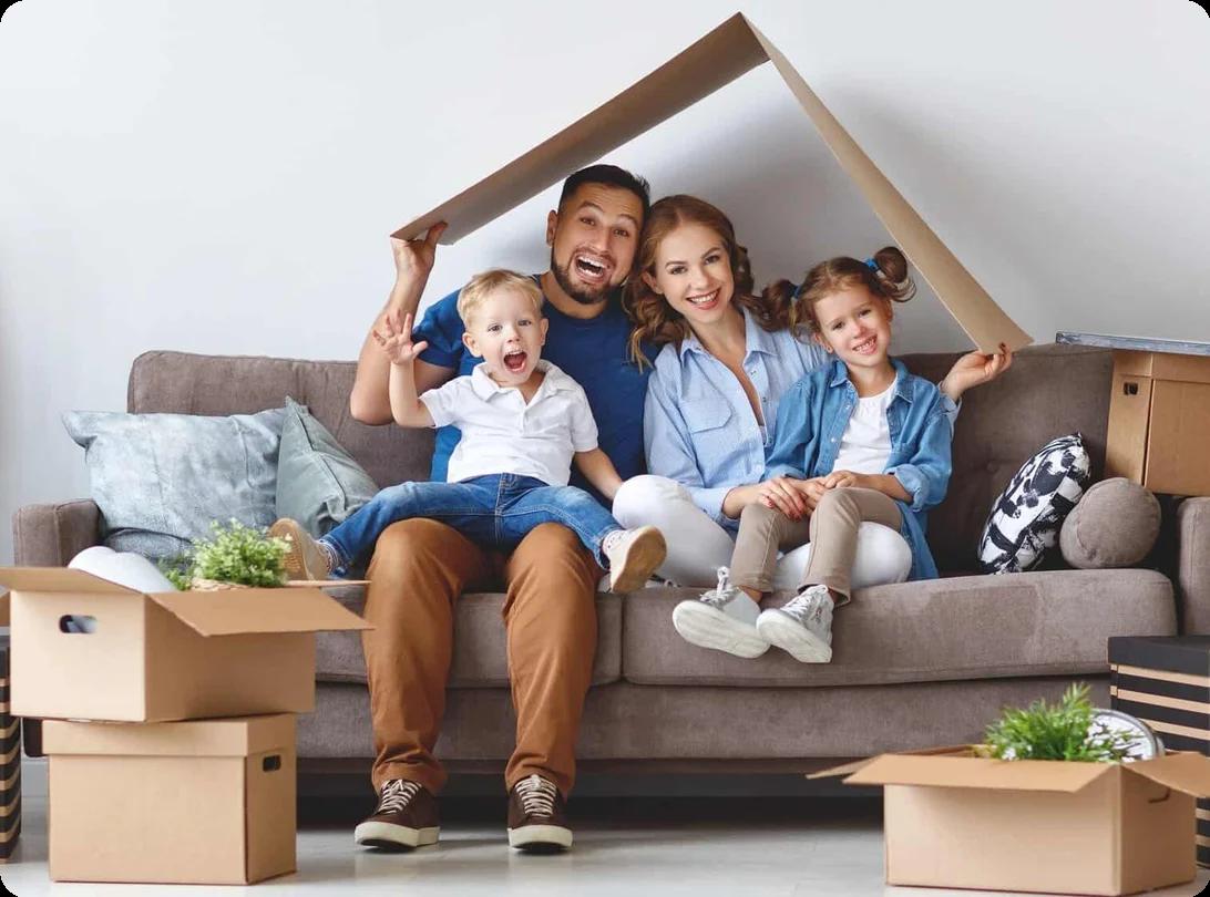 A family with kids playing with moving boxes