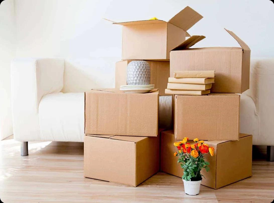 Moving boxes stacked in front of a white couch