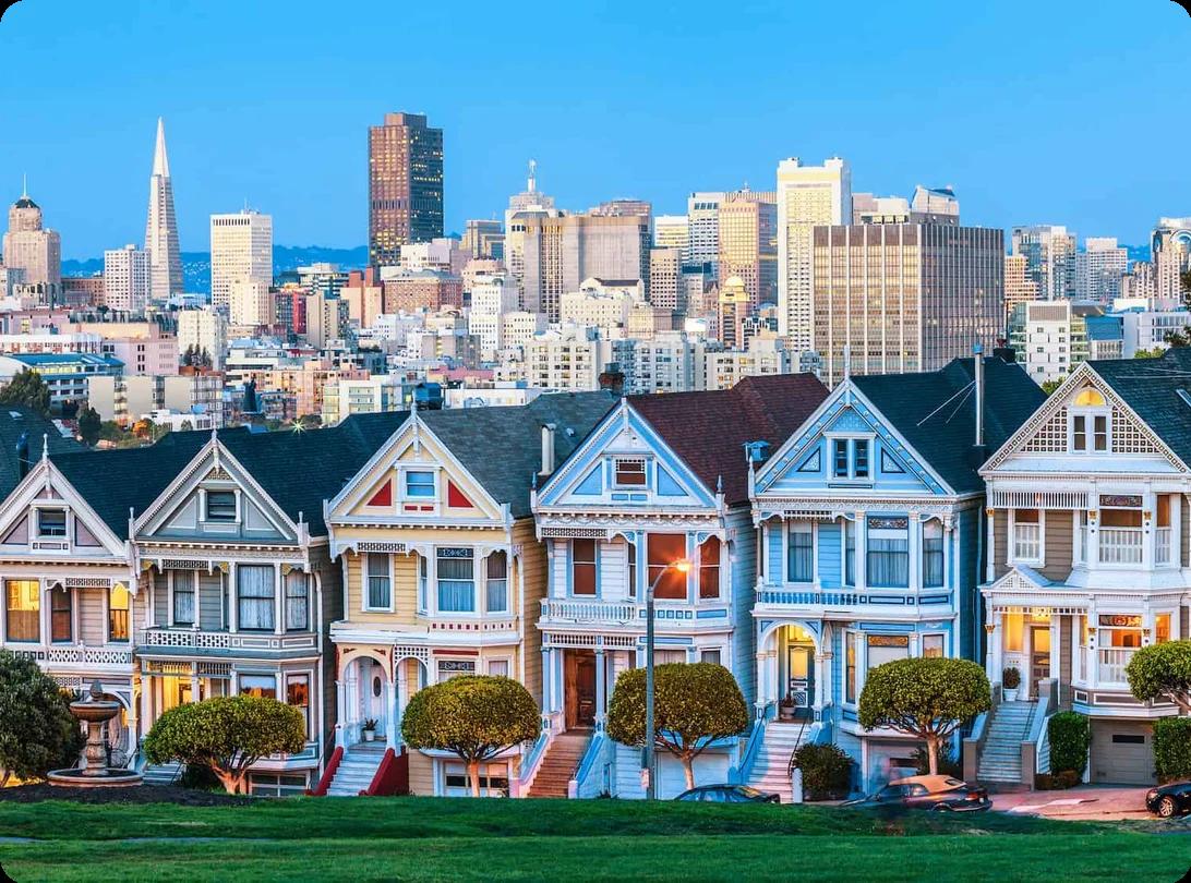 evening view of the Painted Ladies homes in San Francisco. The downtown skyline can be seen in the background