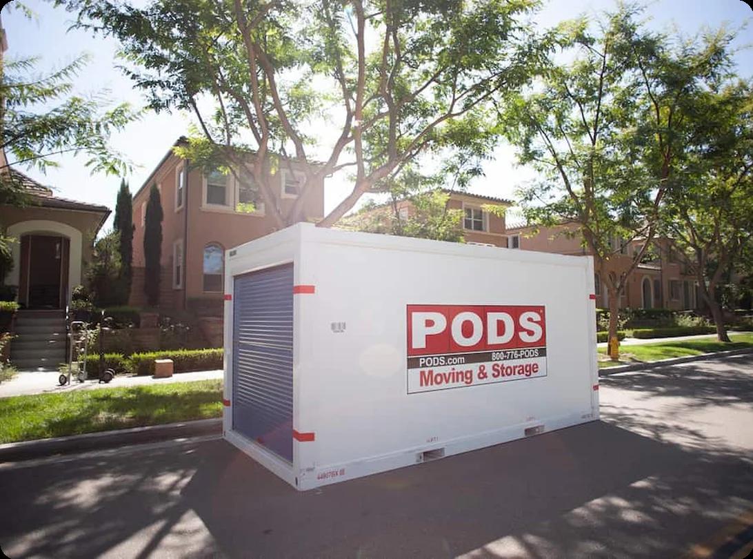A PODS portable storage container being delivered to a driveway