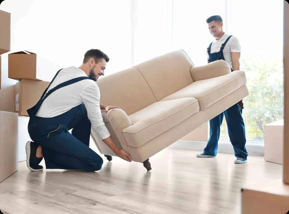 two movers work together to lift a white couch
