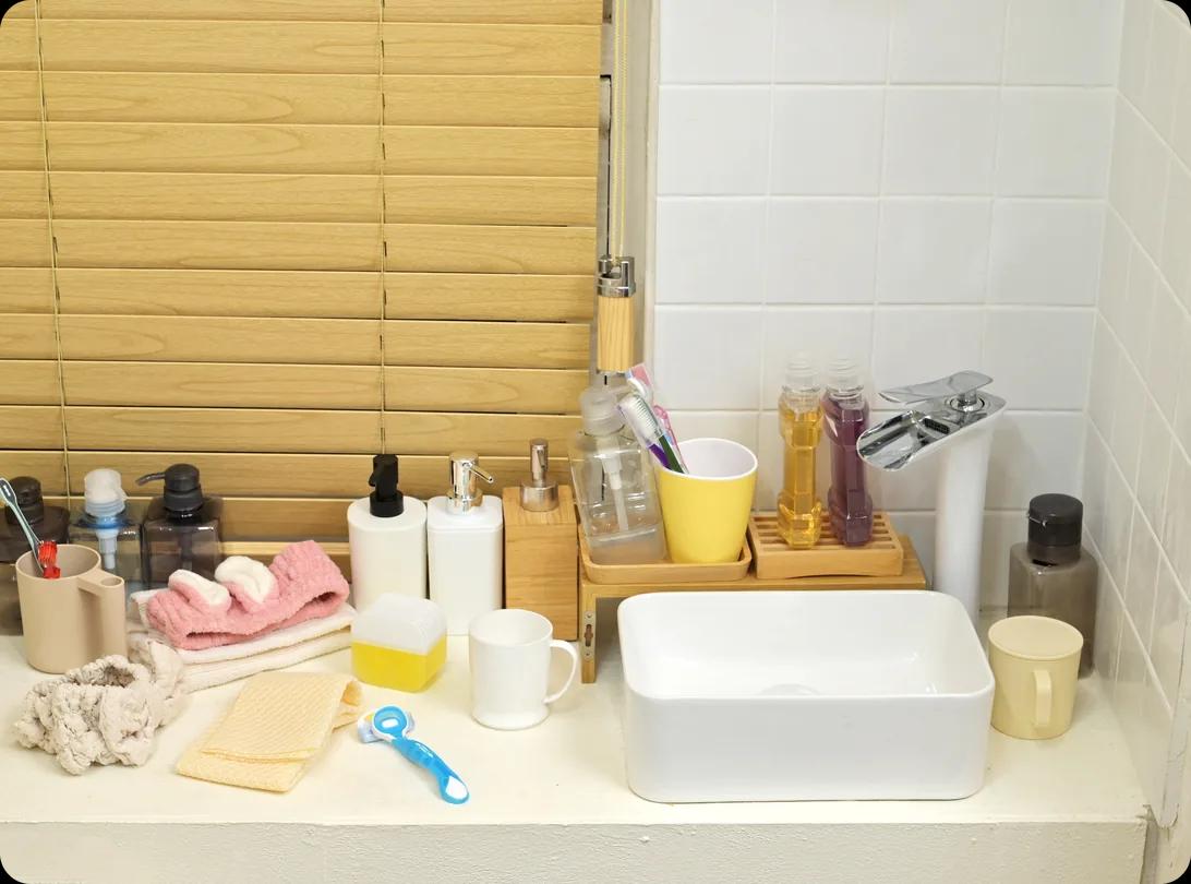 Toiletries and props arranged on a bathroom washbasin