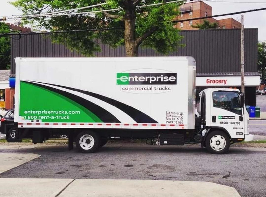 an image of an enterprise rental truck parked on a city street