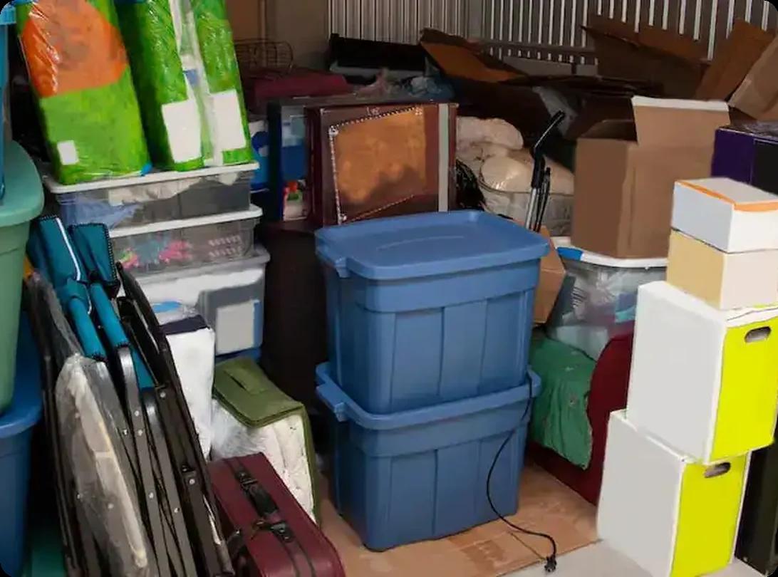 Packed storage unit containing containers, boxes, and furniture