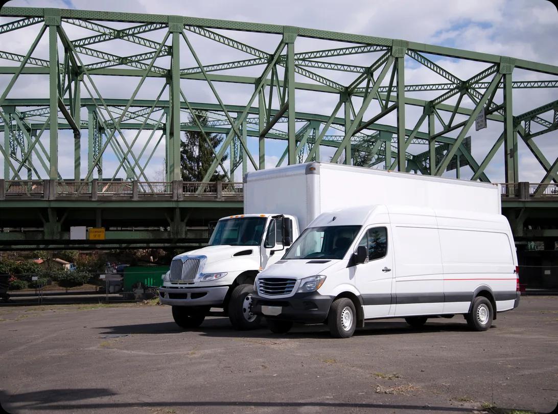 A semi truck and a cargo van parked side by side