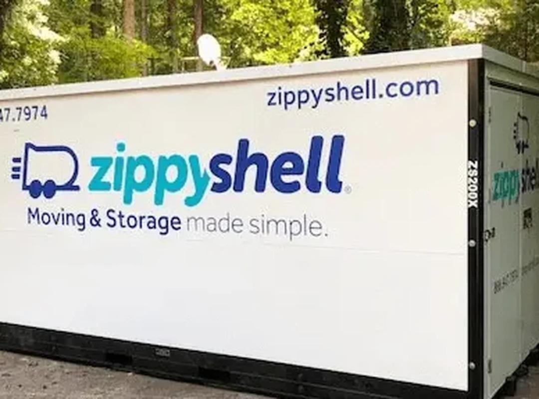 a zippy shell ventilated moving and storage container parked in a residential driveway