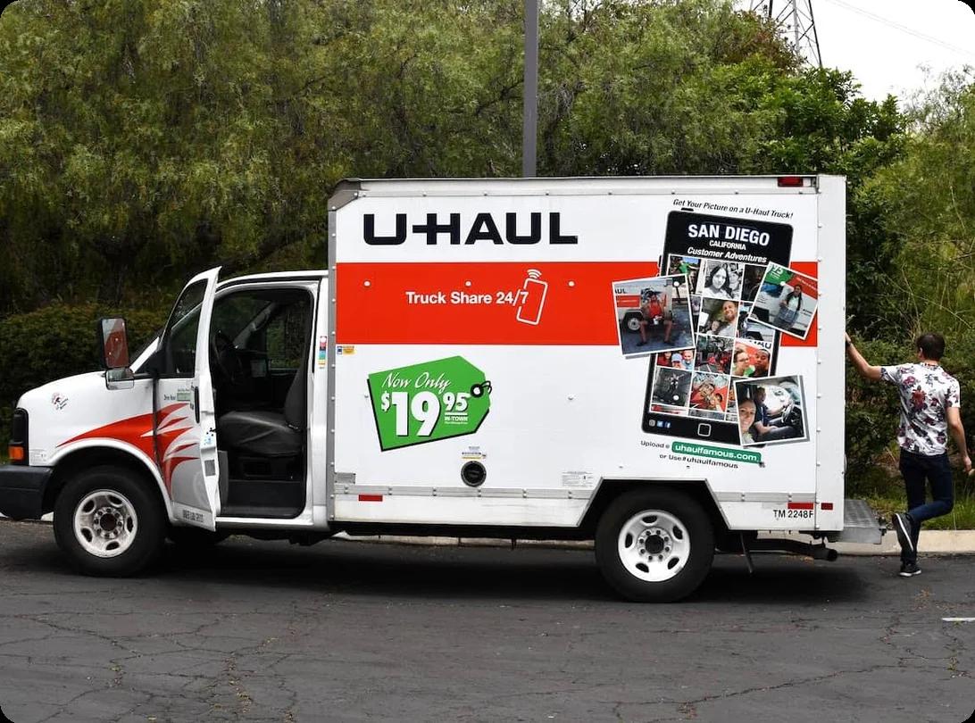 A U-Haul moving truck parked in front of a home with the orange-and-white branding visible