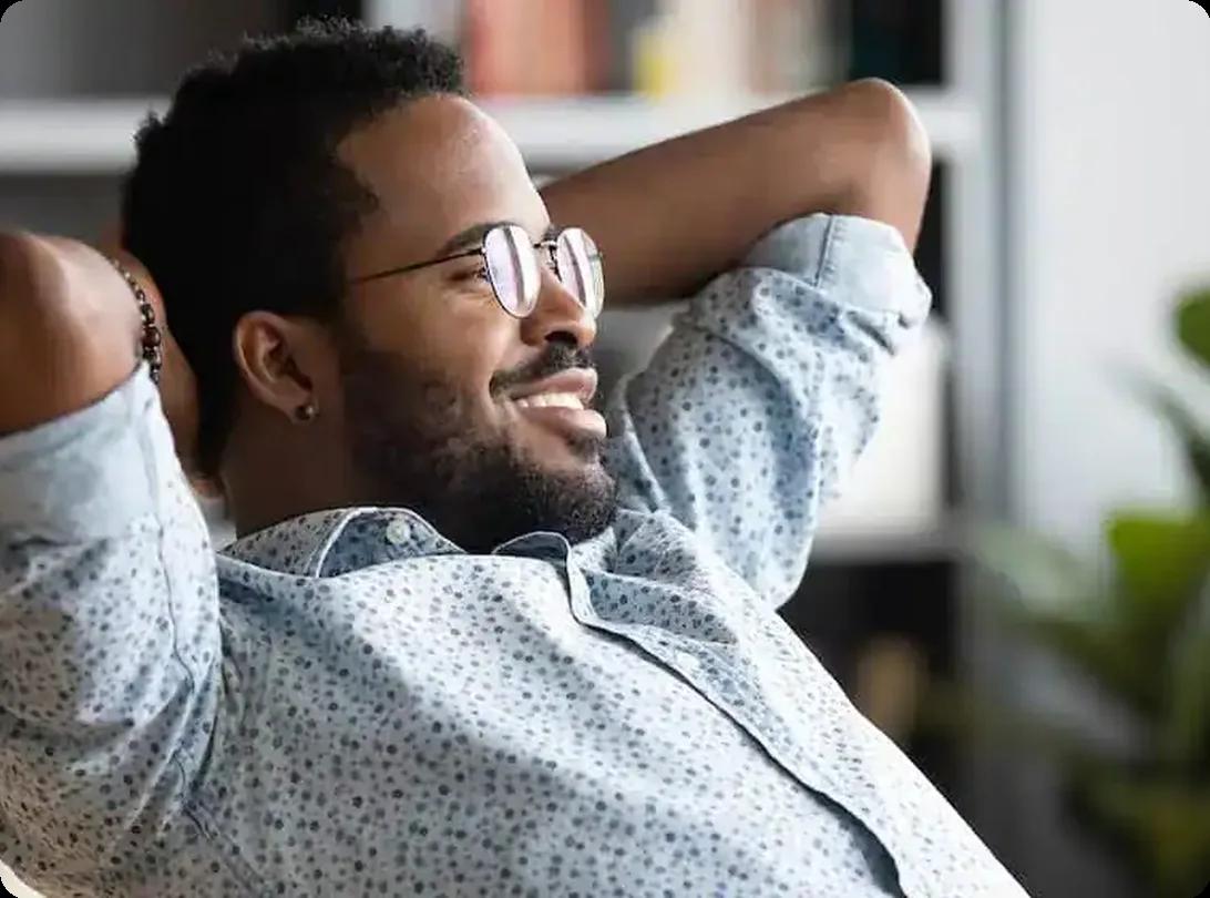 smiling man relaxing at his desk