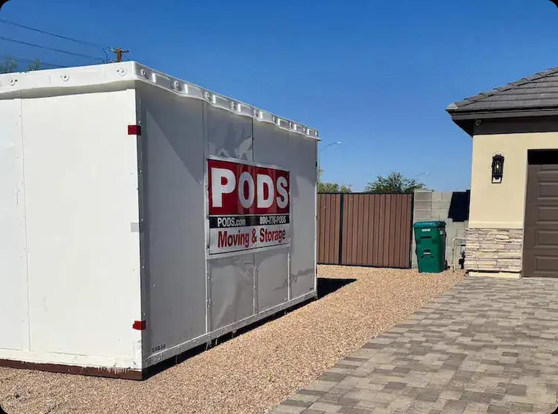 A PODS moving and storage container placed in a residential driveway