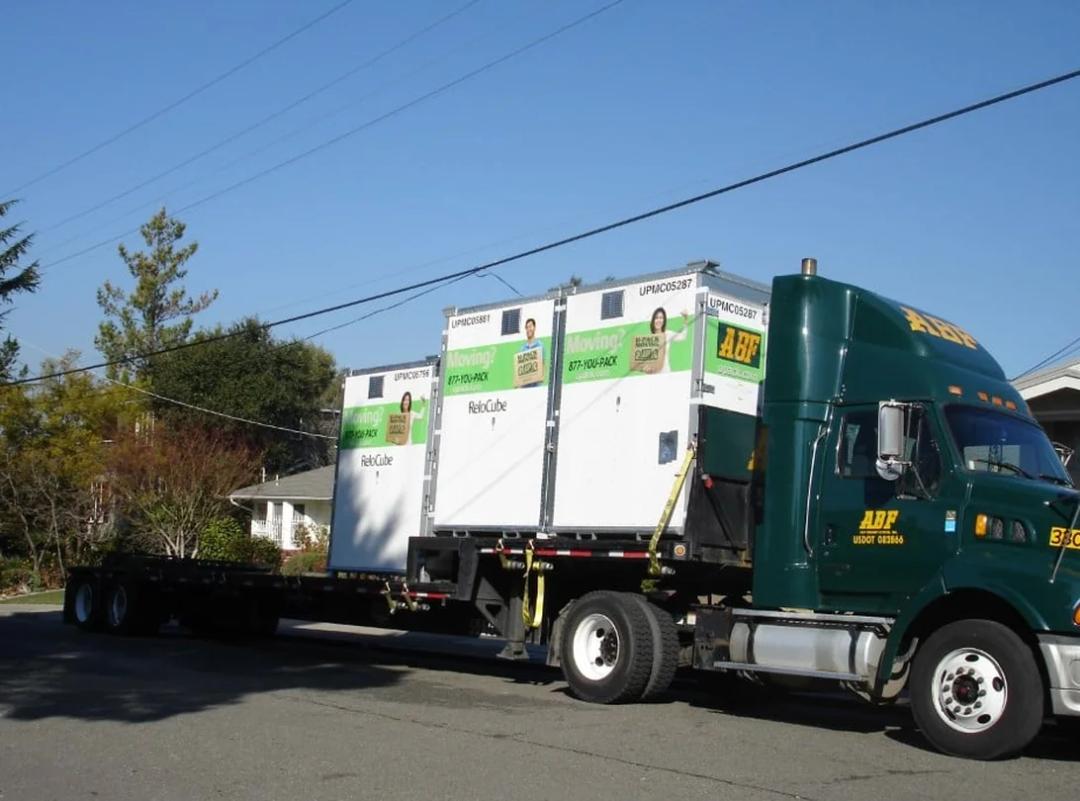an abf u-pack relocube steel moving container parked in a residential driveway