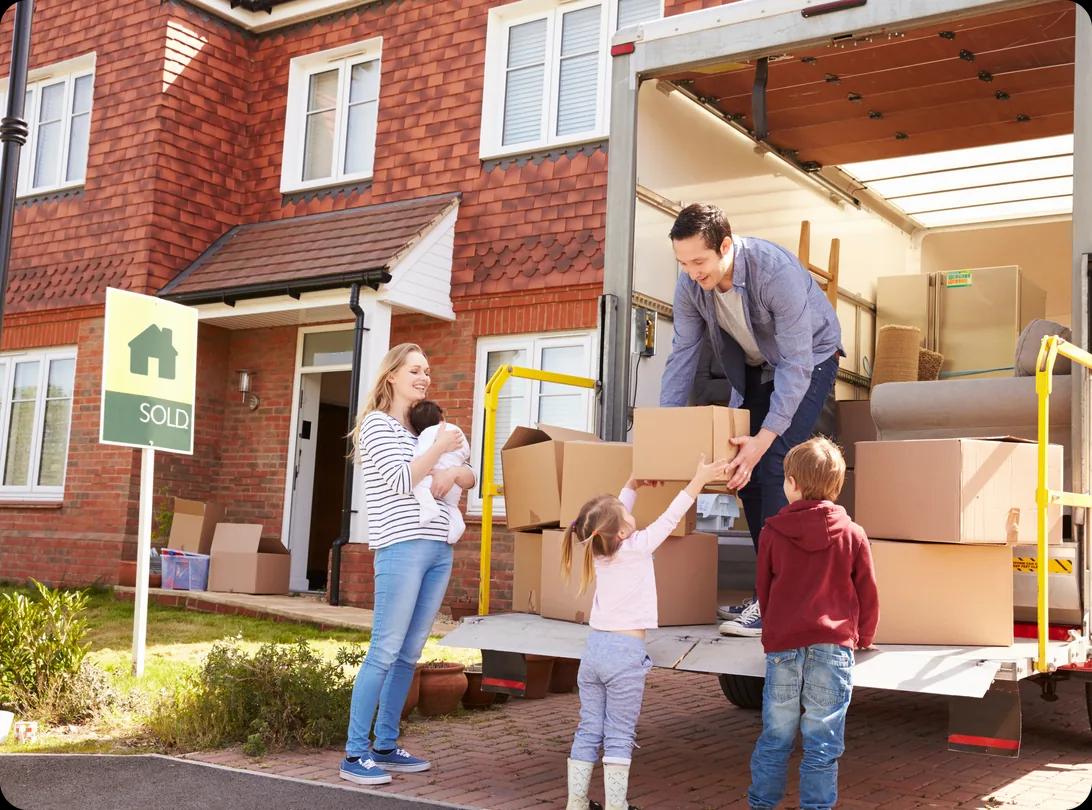 Family unpacking moving boxes from a removal truck