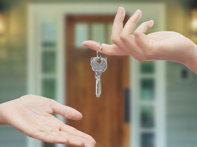 Hands exchanging a pair of keys.