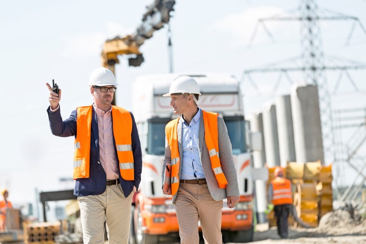Two men in hard hats on a construction site