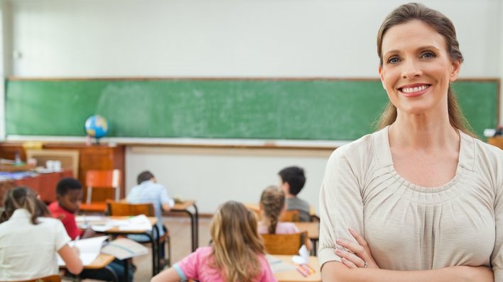 Teacher smiling with arms folded