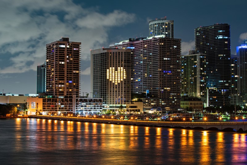 South Beach Miami, FL, skyscrapers at night featuring a light-up heart on one of the buildings.