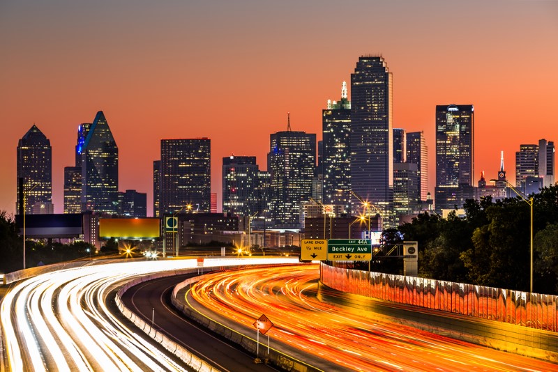 An orange glow time lapse of traffic heading into downtown Dallas, TX.