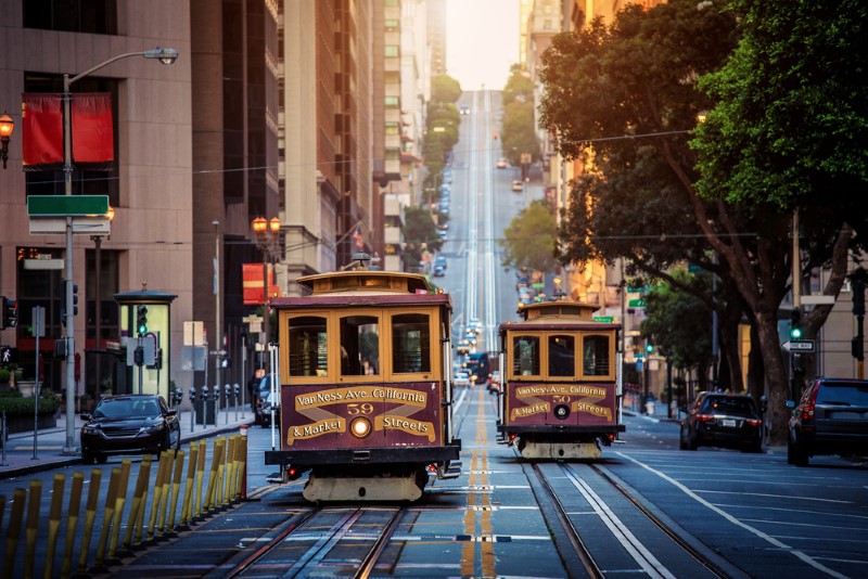 Two trolleys cross paths in hilly San Francisco, California