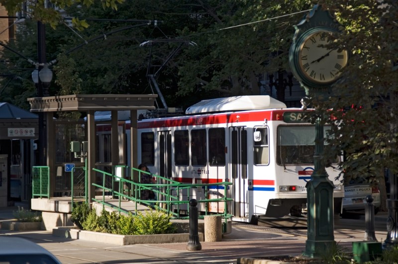 A light rail station in Salt Lake City, Utah, featuring a stationary car on a summer day