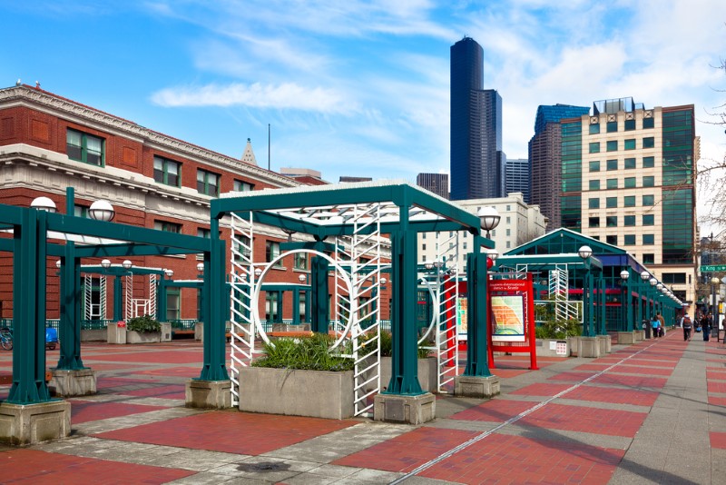 Seattle light rail station in the Chinatown International District. Downtown buildings are pictured in the background.
