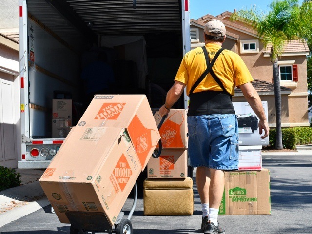 Man loading boxes into a rental truck