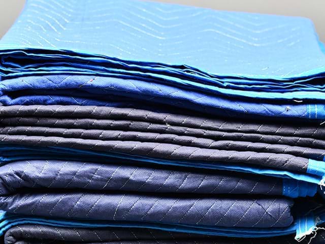 Stack of furniture pads and moving blankets