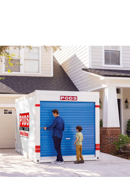 Man and his son opening up a PODS container in their driveway