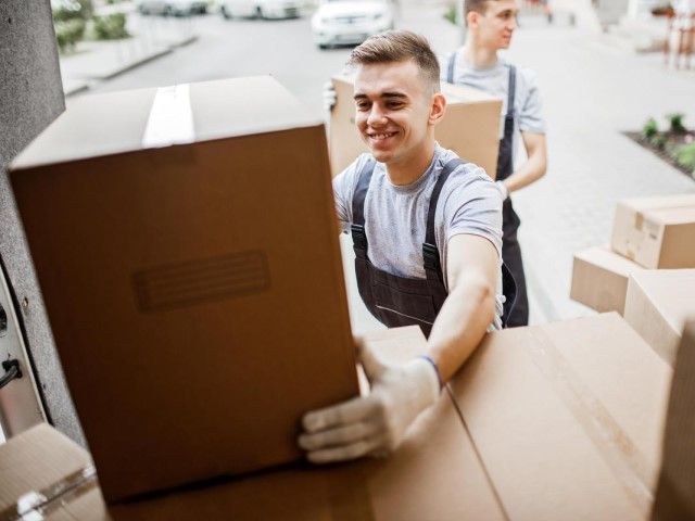 Movers loading boxes into a rental truck