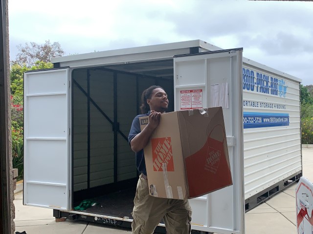 Man loading boxes into a storage container