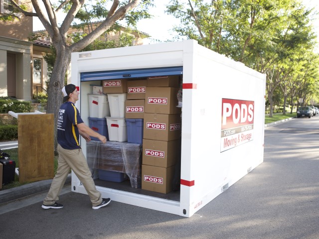 Man loading boxes into a storage container