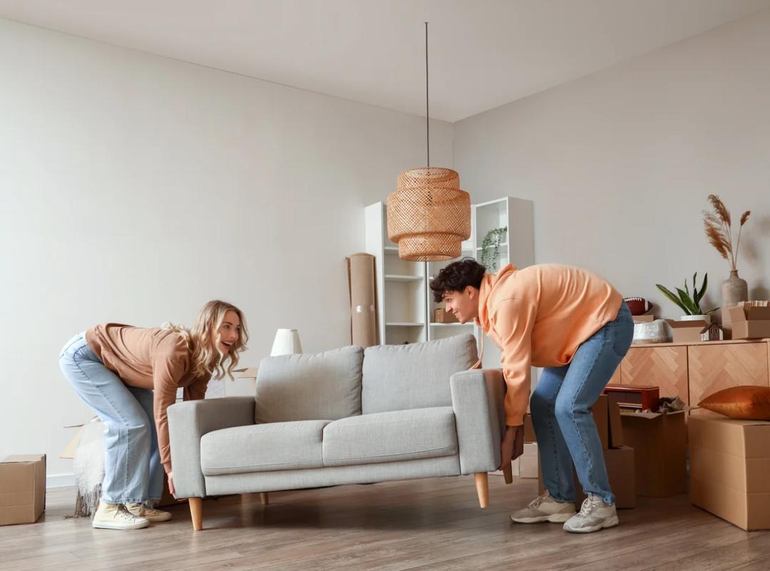 Couple moving a couch